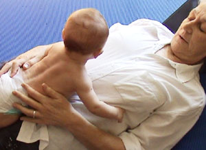 W 4 months prone on carer's chest 