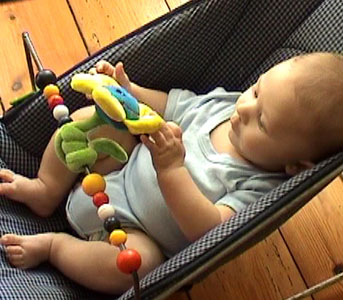 W 4m playing hands in bouncy chair.jpg